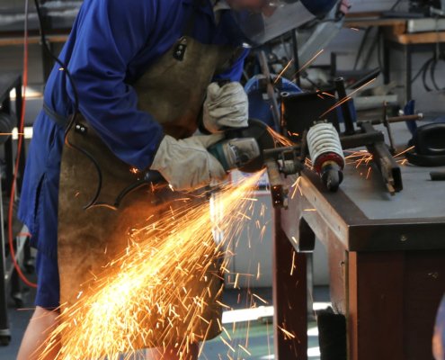 Trident High School Schüler an der Werkbank flext einen Metallrahmen